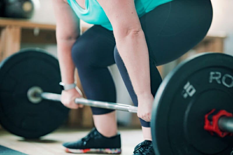Woman lifting Weightlifting barbell at LFT GYM